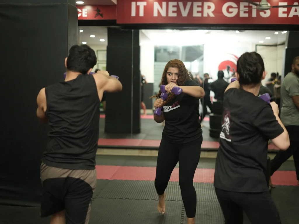 Students practicing partner drills during boxing classes in Gurgaon at StrikeHive Martial Arts Academy